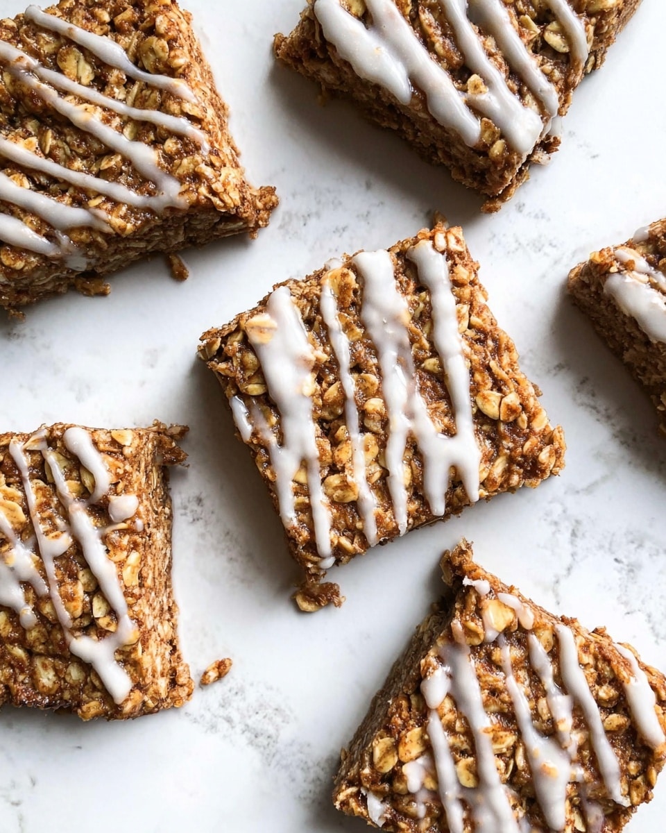 The image shows nine square oat bars arranged loosely on white parchment paper over a white marbled surface. Each bar has a rough texture with visible oats and bits of nuts, colored a warm golden brown. A light drizzle of white icing runs diagonally across the top of each bar, adding contrast. The bars are different sizes with some slightly broken edges, giving a homemade look. Crumbs are scattered around the bars on the parchment paper, enhancing the casual presentation. photo taken with an iphone --ar 4:5 --v 7