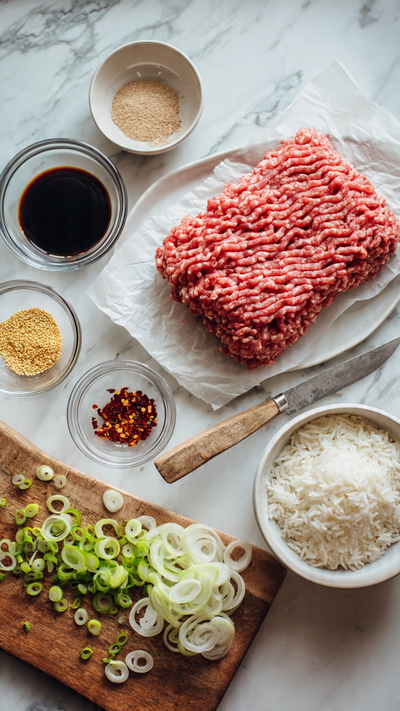 A light white plate holds a large rectangular block of fresh raw ground meat with a wavy texture, resting on a piece of parchment paper. Near it, on a white marbled surface, there is a white bowl filled with cooked white rice showing soft, separate grains. Surrounding these, there are small clear glass bowls each holding different ingredients: golden sesame seeds, red chili flakes, and dark soy sauce. A small white bowl contains a light brown powdered spice. A wooden cutting board sits next to these bowls, scattered with thinly sliced green onions, and a small sharp knife with a wooden handle lies on top of the sliced onions. The whole scene is bright and clean. photo taken with an iphone --ar 4:5 --v 7