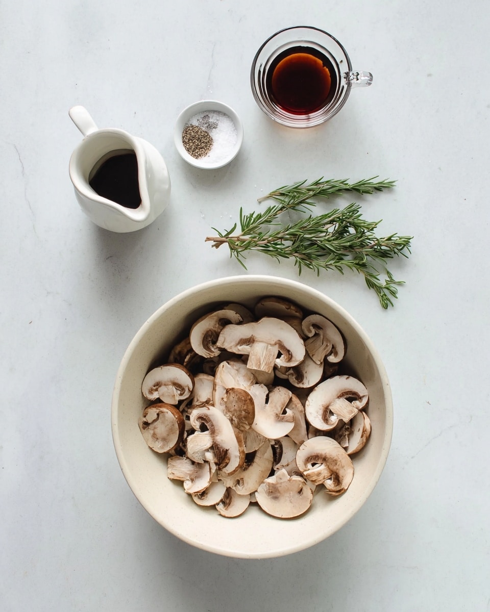 The image shows a white round bowl filled with sliced brown mushrooms, placed on a white marbled surface. Above the bowl, there is a small white dish holding salt and pepper, a small white jug, a small clear glass cup filled with a dark brown liquid, and a sprig of fresh green rosemary. The scene is simple and clean, with the neutral colors of the mushrooms and ingredients standing out against the white marbled background. photo taken with an iphone --ar 4:5 --v 7