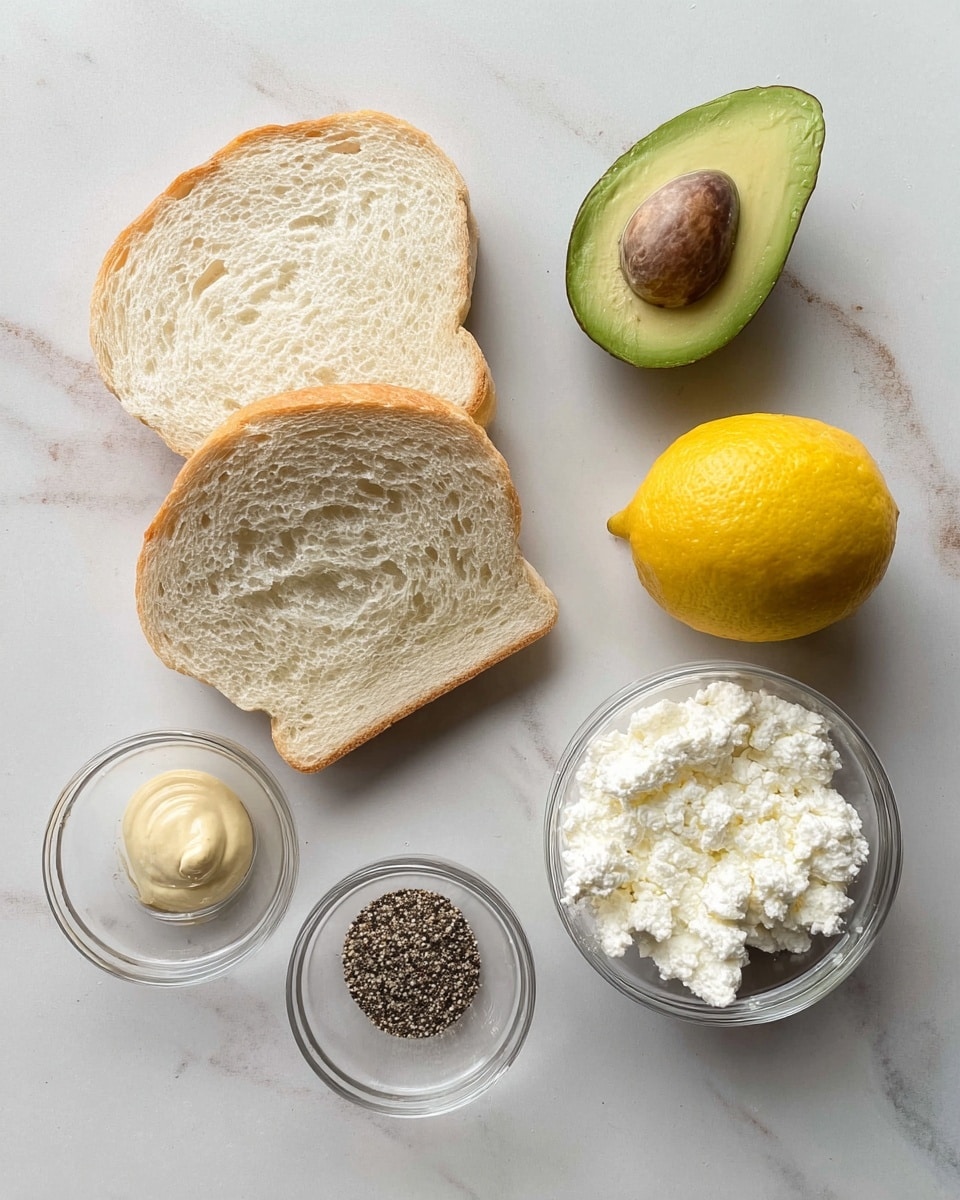 Two slices of white bread with a soft and airy texture sit on a white marbled surface, next to half an avocado showing its green flesh and brown seed. Below the avocado is a whole bright yellow lemon. To the right of the lemon is a small clear bowl filled with white cottage cheese that looks creamy and lumpy. Below the bread and lemon are two more small clear bowls; one contains a beige mustard dollop while the other has a mix of cracked black pepper. All items are arranged neatly with space between them, photo taken with an iphone --ar 4:5 --v 7