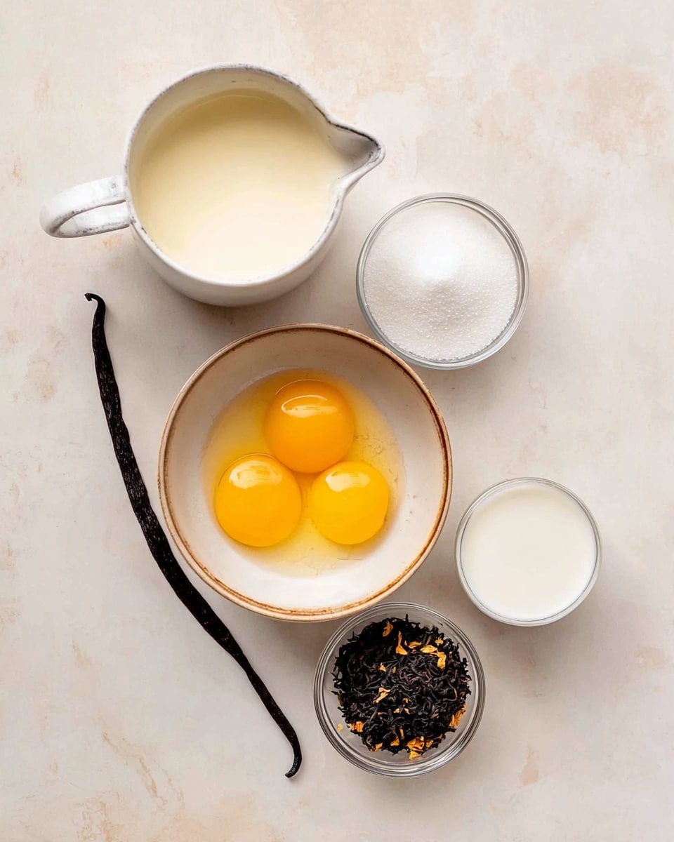 The image shows five small bowls and a vanilla bean arranged on a white marbled surface. The biggest bowl, near the bottom, is off-white with a light brown rim and holds three raw egg yolks, bright yellow with a shiny texture. To its top left is a white measuring cup filled with cream, looking smooth and creamy with a slightly off-white color. Above it, a small white container holds sugar that is pure white and fine. Next to the sugar, slightly to the right, is a small clear glass filled with a thick white liquid, smooth and glossy. To the right of the eggs, a tiny round clear bowl holds loose black tea leaves mixed with some small orange bits, giving it a rough, uneven texture. On the far left edge, there is a long black vanilla bean with a shiny, slightly wrinkled surface. The whole setup is clean and bright. photo taken with an iphone --ar 4:5 --v 7
