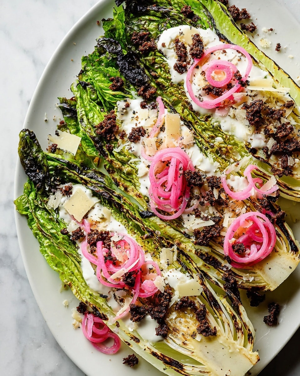 A white plate holds several large, grilled romaine lettuce halves with char marks visible on the green leaves and light green inner parts. On top, there is a creamy white dressing drizzled unevenly, scattered with small chunks of dark brown crispy croutons and thin, curly rings of bright pink pickled onions. Thin shavings of white cheese add texture, all sitting on a white marbled surface. The dish's colors are mainly green, white, pink, and dark brown, with a fresh and slightly smoky look. Photo taken with an iphone --ar 4:5 --v 7