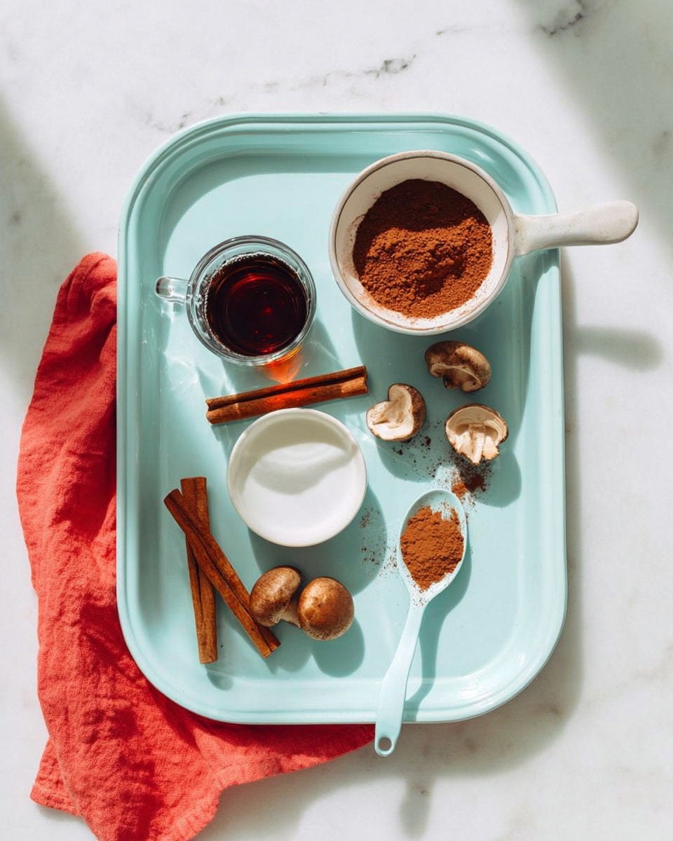 A light blue tray sits on a white marbled surface with a soft red cloth partly under it on the left side. On the tray, there is a small clear glass cup with dark brown liquid near the top center. Next to it, to the right, is a small white bowl filled with cocoa powder. Below these, a white spoon with a light blue handle holds a small mound of powdered spice, and a silver spoon with some brown paste rests diagonally on the tray. Three brown cinnamon sticks are arranged near the left bottom corner, and three whole mushrooms with brown caps and stems sit near the bottom right. A white cup with white liquid is placed at the bottom left side of the tray. The scene is bright with soft natural light, and the focus is sharp. photo taken with an iphone --ar 4:5 --v 7