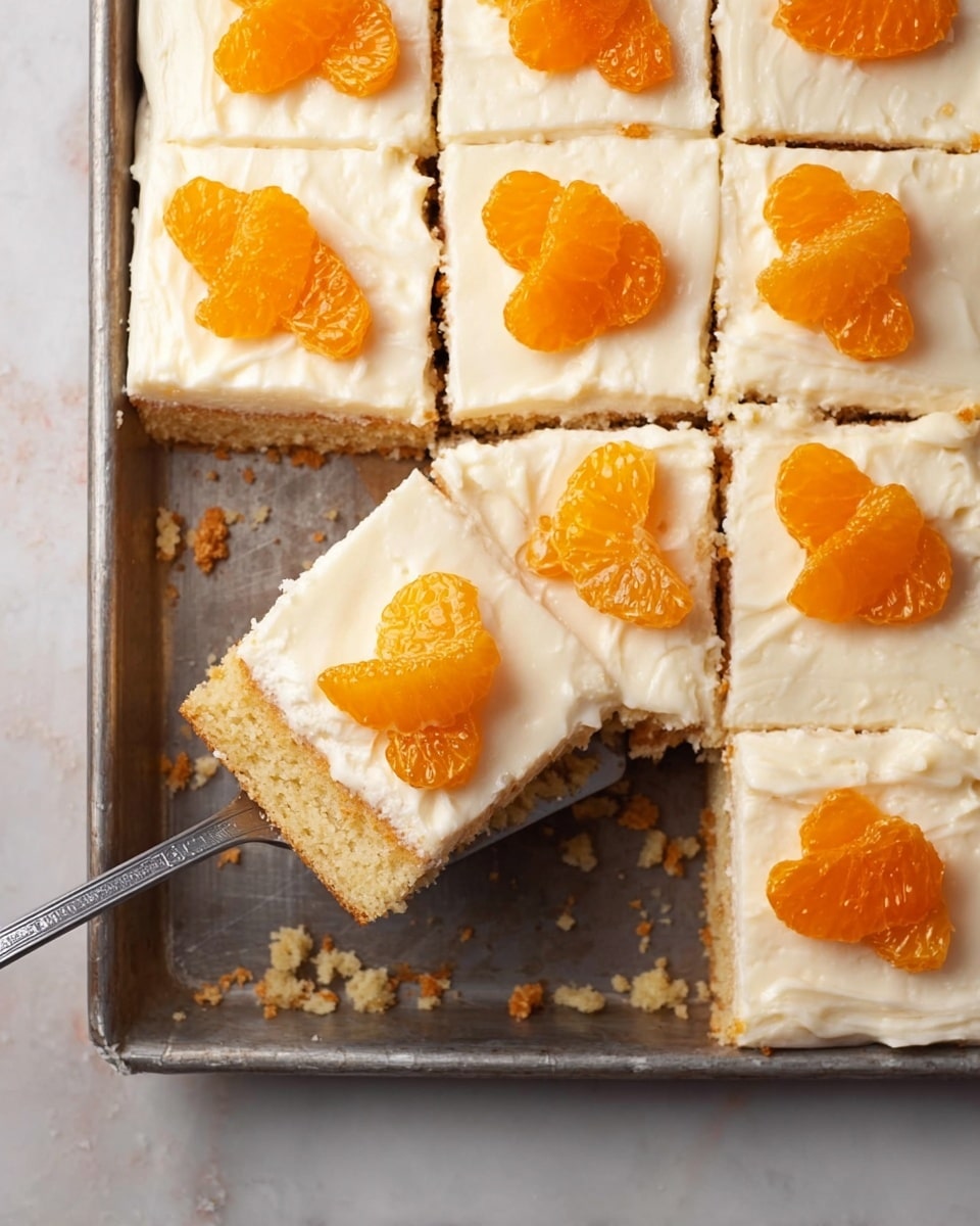 A metal baking tray holds nine square pieces of cake, with one piece being lifted by a flat spatula. Each square has two layers: a light golden brown crumbly base and a thick creamy white frosting layer on top. Each piece is decorated with two bright orange mandarin slices placed on the frosting in a neat row. The tray sits on a white marbled surface with some crumbs scattered around. photo taken with an iphone --ar 4:5 --v 7