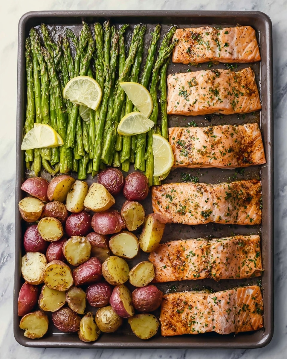 A rectangular baking tray holds a cooked meal arranged in three horizontal rows. The top row has long green asparagus spears with a few thin yellow lemon slices scattered on top. The middle row features four golden brown salmon fillets with a slightly crispy texture and sprinkled herbs. The bottom row contains small red and cream-colored potato halves seasoned with herbs, showing a roasted, slightly crisp surface. The tray sits on a white marbled surface. Photo taken with an iphone --ar 4:5 --v 7