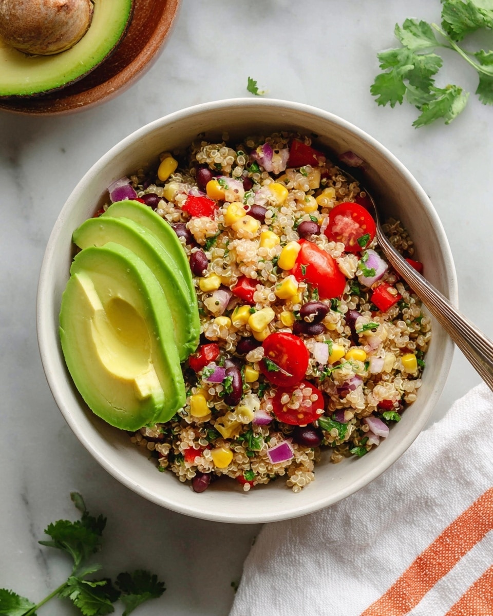 A white bowl filled with a colorful quinoa salad showing three main layers: the bottom is a mix of light beige quinoa grains with scattered black beans, yellow corn kernels, red bell pepper pieces, purple onion bits, green herbs, and halved bright red cherry tomatoes; on top, there are three smooth, light green avocado slices placed on the left side; next to the avocado, a silver fork rests inside the bowl, partially sunk into the salad. The bowl sits on a white marbled surface with some green cilantro leaves nearby and a white cloth with thin orange stripes on the lower right corner. Photo taken with an iphone --ar 4:5 --v 7