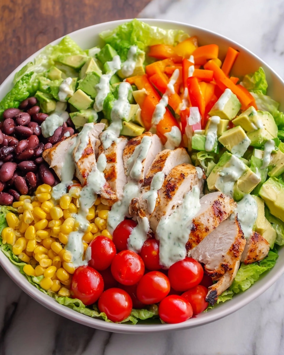 A white bowl filled with six main layers arranged in sections, starting with light green lettuce leaves at the bottom, followed by grilled chicken slices with light brown grill marks on one side. Next to the chicken, there are bright orange bell pepper strips. Beside the peppers, there are dark red kidney beans, and next to them, bright yellow corn kernels. In the center, there are green avocado cubes, with an uneven white dressing drizzled over the chicken, peppers, avocado, beans, and corn. At the front, vibrant red quartered cherry tomatoes complete the colorful look, all placed on a white marbled surface. photo taken with an iphone --ar 4:5 --v 7