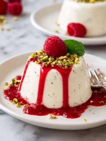 Silky Vanilla Panna Cotta with Raspberry Coulis and Pistachio Garnish Recipe
