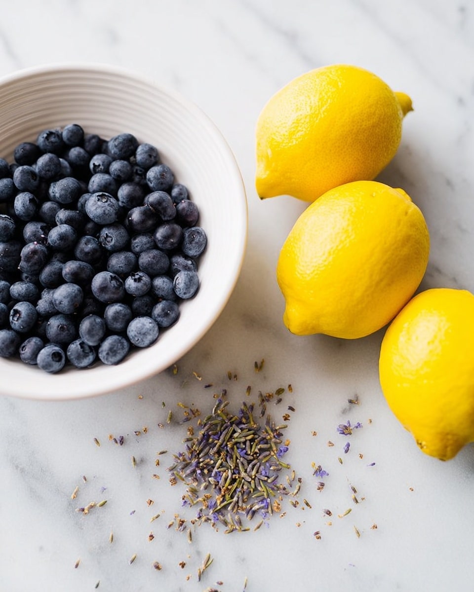 A white bowl filled halfway with small, round, dark blue blueberries sits on a white marbled surface. Next to the bowl are three bright yellow lemons with a rough texture, resting close together. Scattered on the marble between the lemons and the bowl are small bits of dried lavender in light purple and brown tones. The image has a clean and fresh look with soft natural light. photo taken with an iphone --ar 4:5 --v 7