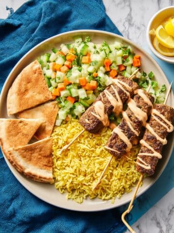 Spiced Beef Skewers with Rice Bowls, Tomato Cucumber Salad, Lemon Hummus & Toasted Pitas Recipe