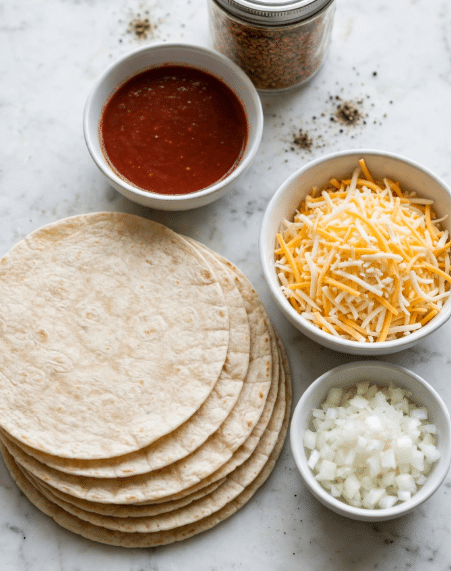 The image shows a stack of several round, plain flour tortillas placed on a white marbled surface. To the right side of the tortillas, there is a white bowl filled with shredded yellow and white cheese, with the cheese strands mixed and thin. Below this bowl, a smaller white bowl contains finely chopped white onions. Above the tortillas, a small white bowl holds a red salsa sauce with a smooth texture. Behind the salsa bowl, a glass jar with brown contents and a silver lid is partially visible, along with some ground black pepper scattered nearby on the white marbled surface. Photo taken with an iphone --ar 4:5 --v 7