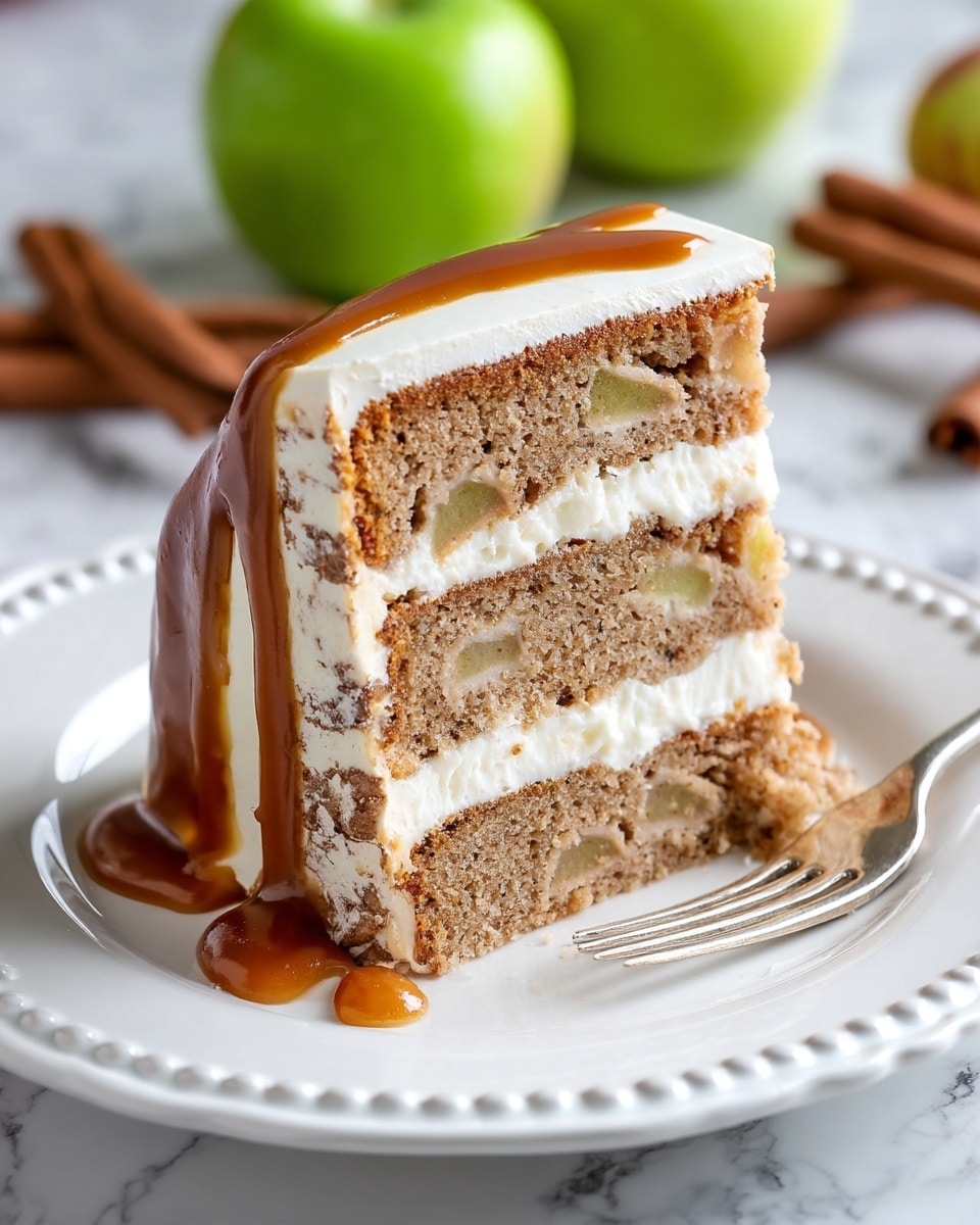 A slice of three-layer light brown apple cake with visible small apple pieces inside each layer, separated by two even layers of smooth white cream filling, all covered by a glossy caramel glaze dripping slightly at the bottom. The cake is placed on a white plate with a scalloped edge decorated with raised dots. A silver fork rests on the right side of the plate. The background has a white marbled texture with some green apples and cinnamon sticks blurred around. Photo taken with an iphone --ar 4:5 --v 7